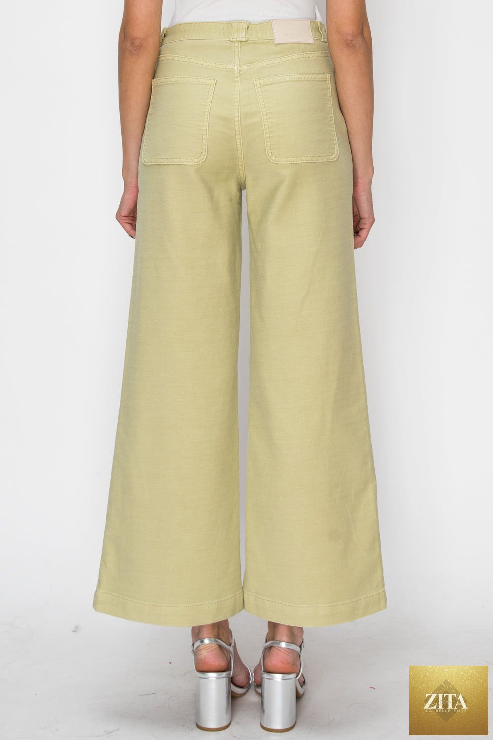 High rise wide-leg sage jeans by Artemis Vintage, showing front view with fitted waist and relaxed wide-leg style.