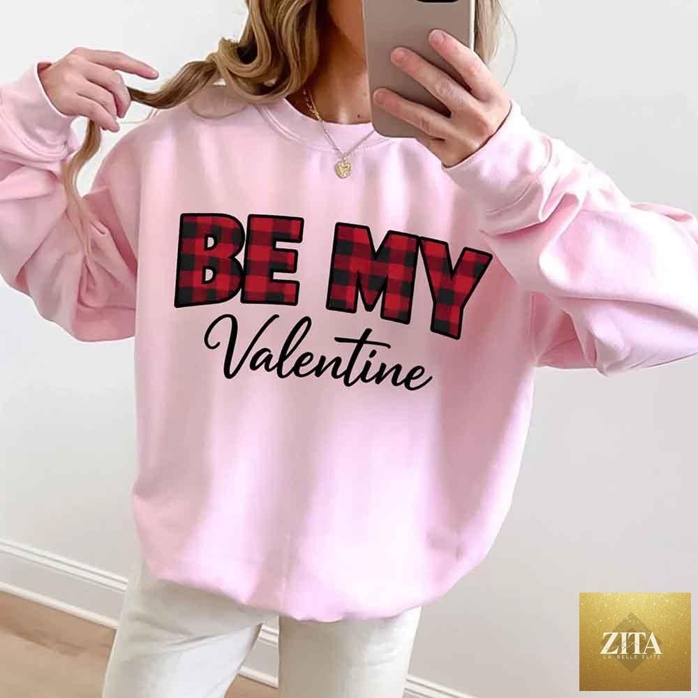 Red and black buffalo plaid crewneck sweatshirt with "Be My Valentine" text from Adorb Custom Tees, perfect for Valentine's Day.