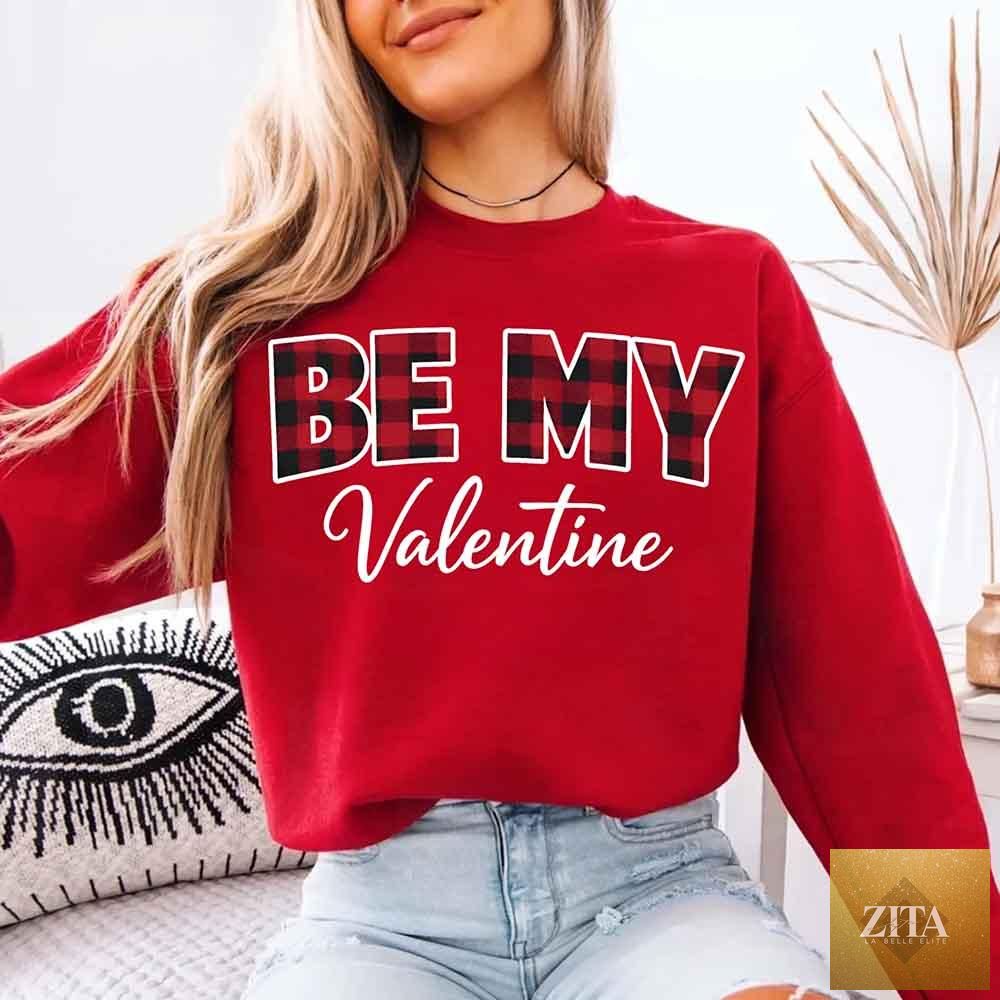 Red and black buffalo plaid crewneck sweatshirt with "Be My Valentine" text from Adorb Custom Tees, perfect for Valentine's Day.