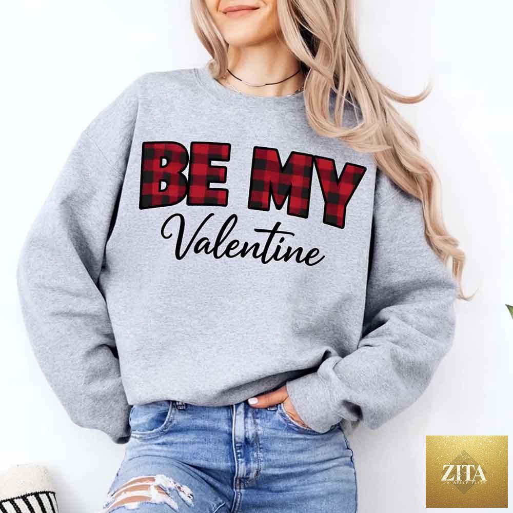 Red and black buffalo plaid crewneck sweatshirt with "Be My Valentine" text, made by Adorb Custom Tees, perfect for Valentine's Day.