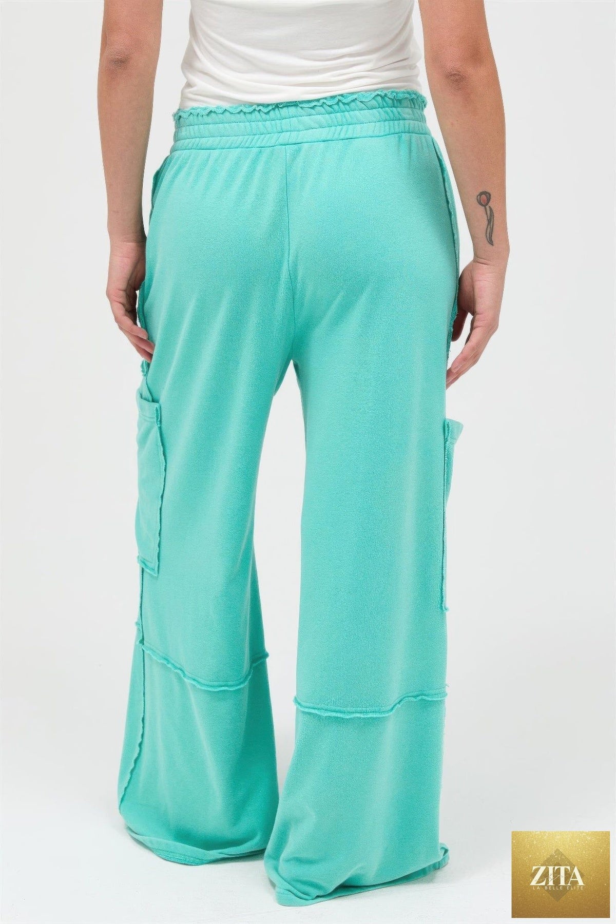 Mineral wash wide leg cargo pants from Tigbul's Variety Fashion Shop, featuring multiple pockets and relaxed fit.