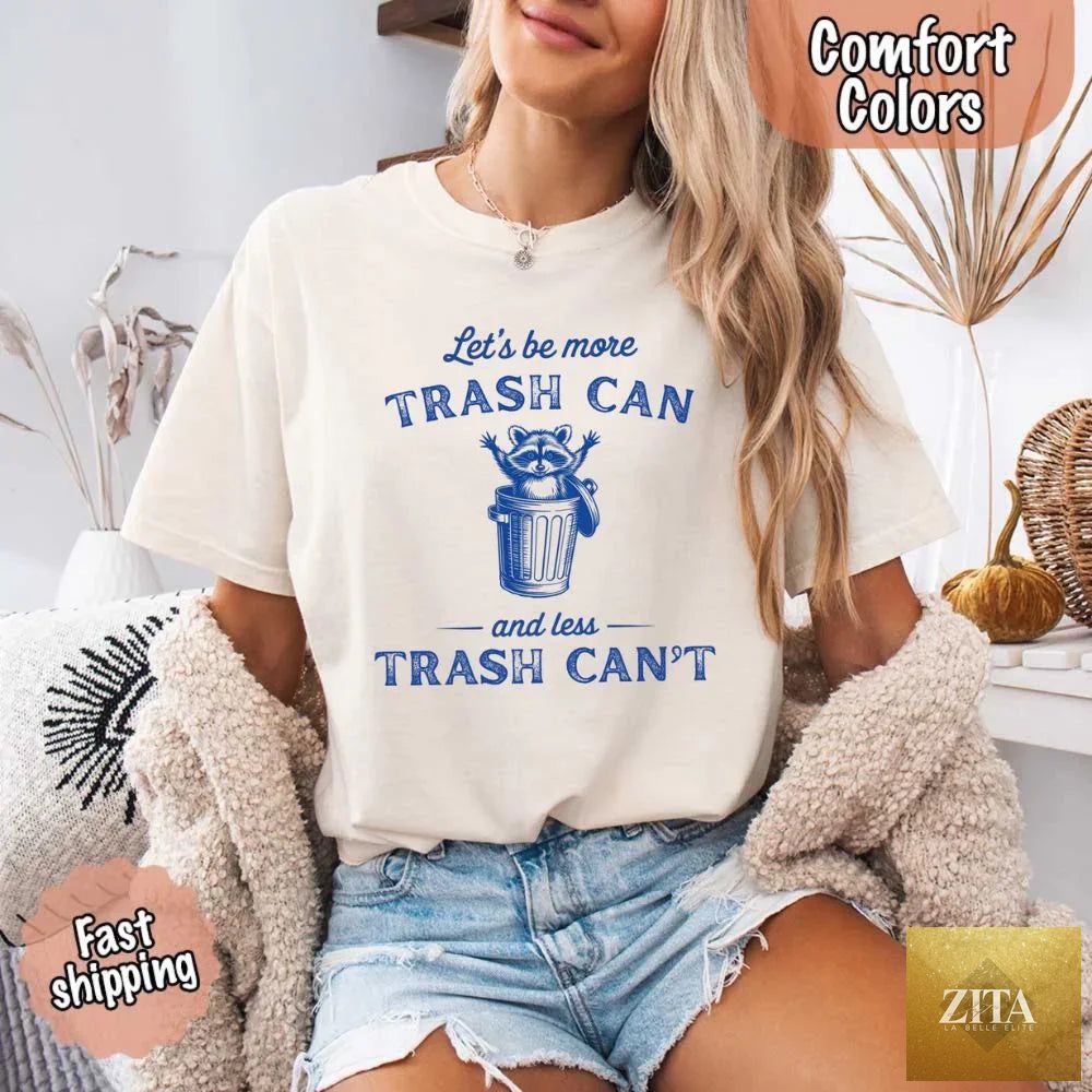 Comfort Colors raccoon funny T-shirt by Adorb Custom Tees featuring the phrase "Let's Be More Trash Can, Less Trash Can" with raccoon graphic.