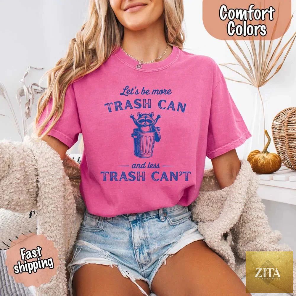 Comfort Colors T-shirt featuring a humorous raccoon design with the slogan “Let’s Be More Trash Can” by Adorb Custom Tees.