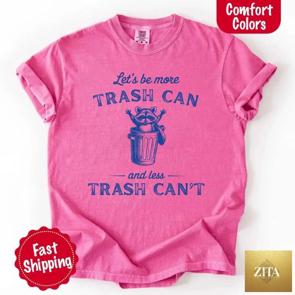 Comfort Colors T-shirt featuring a humorous raccoon design with the phrase "Let’s Be More Trash Can and Less Trash Can" by Adorb Custom Tees.