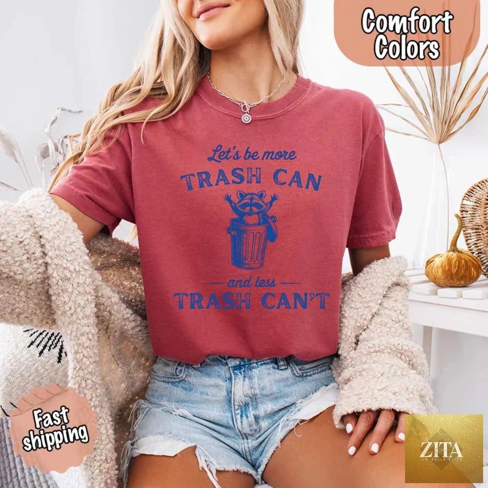 Comfort Colors funny T-shirt featuring a raccoon and trash can graphic from Adorb Custom Tees. Casual, humorous apparel.