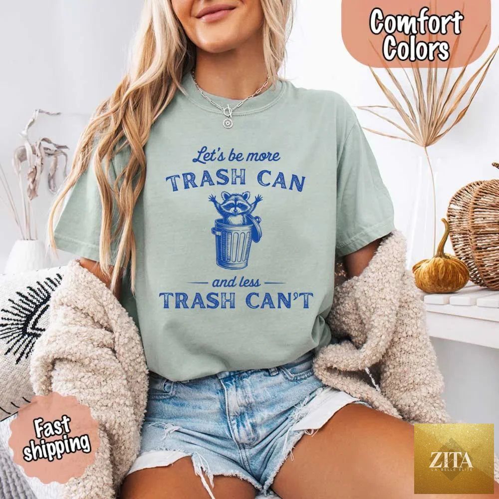 Comfort Colors Let's Be More Trash Can Raccoon funny T-shirt by Adorb Custom Tees, featuring a raccoon graphic on a casual tee.