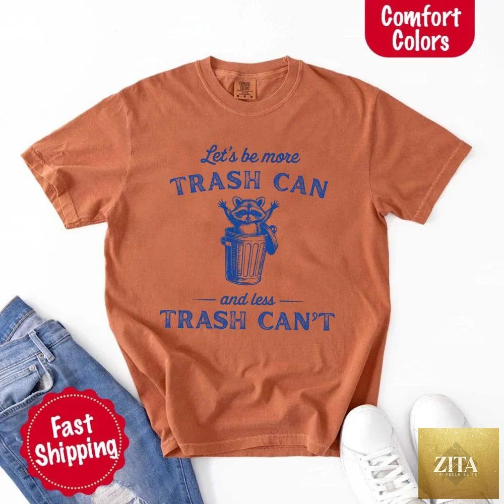 Comfort Colors "Let's Be More Trash Can, Less Trash Can" raccoon funny T-shirt by Adorb Custom Tees showing a raccoon graphic.