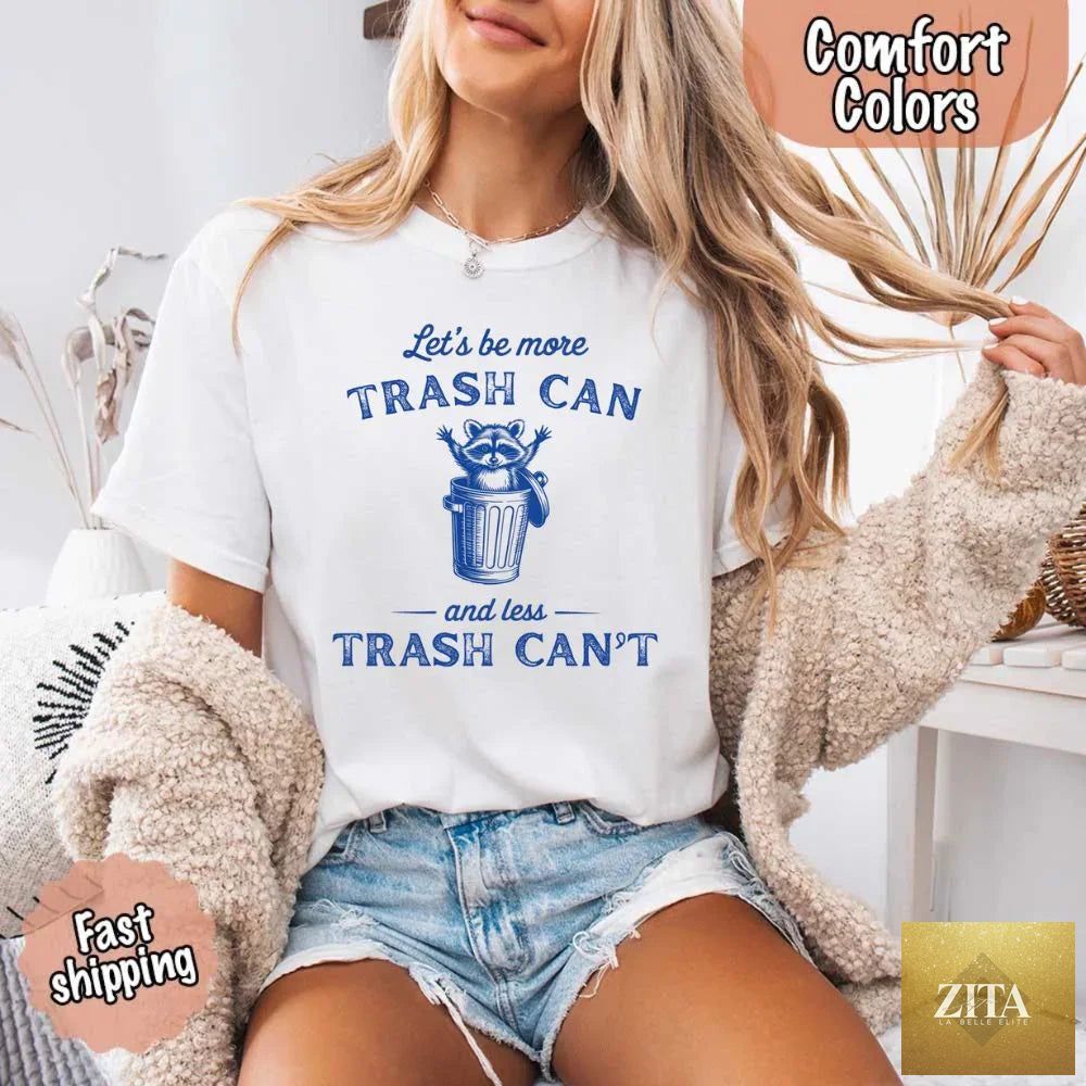 Comfort Colors T-shirt featuring a humorous raccoon design with the phrase "Let's Be More Trash Can, Less Trash Can" by Adorb Custom Tees.