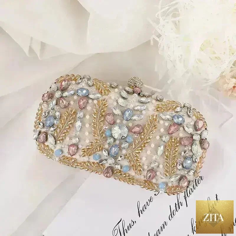 Femstylo luxury rhinestone clutch bag with crystal embellishments, featuring a chain shoulder strap for wedding or party occasions.