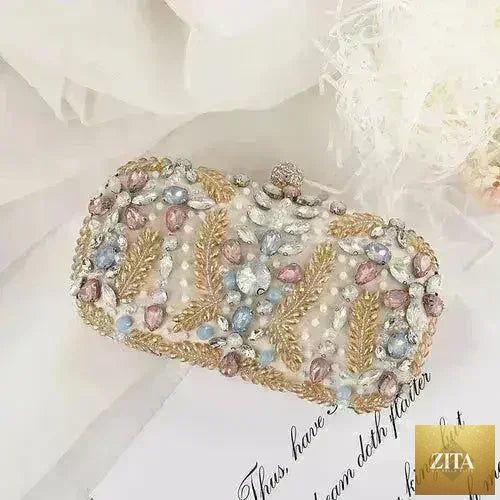 Femstylo luxury rhinestone clutch bag with crystal embellishments, perfect for weddings and parties, featuring a chain shoulder strap.