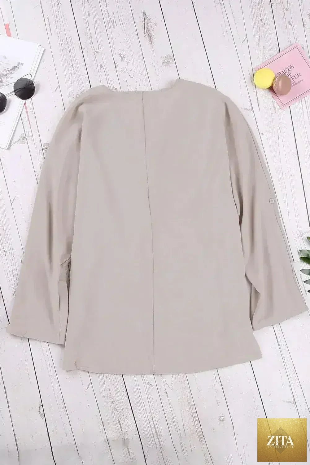 Elegant apricot V-neck blouse by Femstylo featuring 3/4 sleeves and a high-low hem, perfect for stylish casual or dressy occasions.