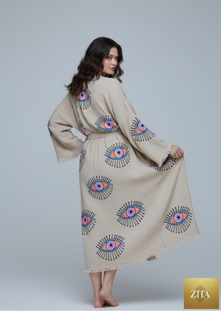Hand-printed beige kimono with evil eye design by Zita La Belle Elite, showcasing intricate patterns and flowy fabric.