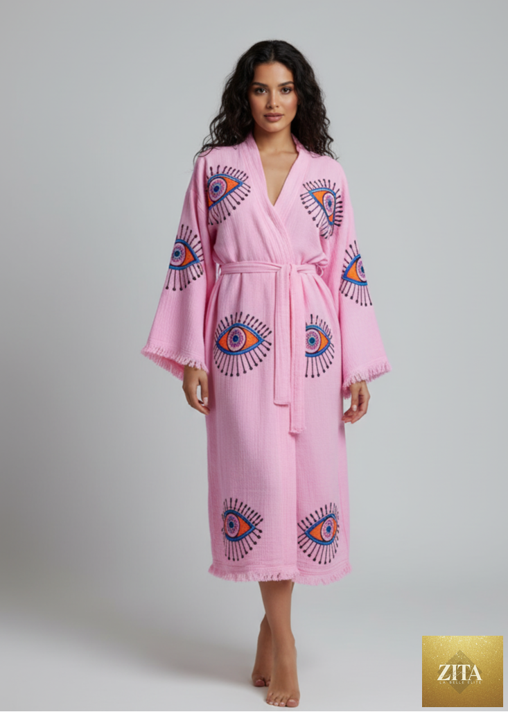 Hand-printed pink kimono with evil eye design by Zita La Belle Elite, featuring a flowing, elegant style and intricate pattern.