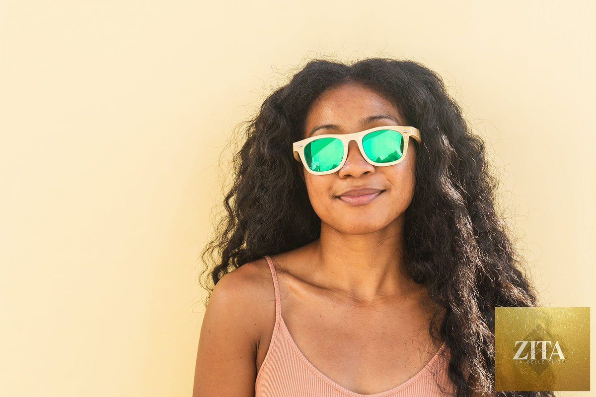 Bamboo floating sunglasses by Eastern Outer with round frames and polarized lenses, resting on a wooden surface.
