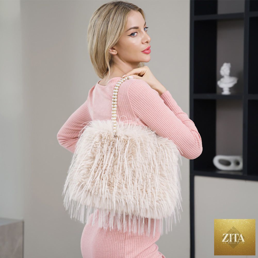 Beige fluffy faux fur shoulder bag with pearl strap and compact design, by Madeline Love, for stylish everyday use.