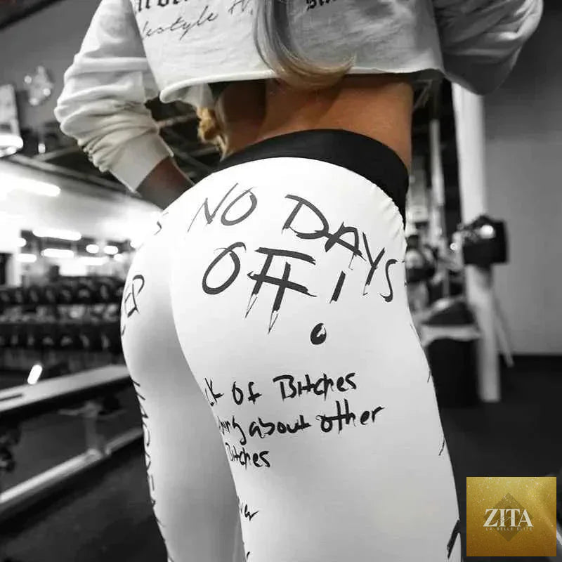 Thrixine Oshoplive letter print yoga leggings featuring black fabric with bold white letter designs, stretchy and comfortable for workouts.