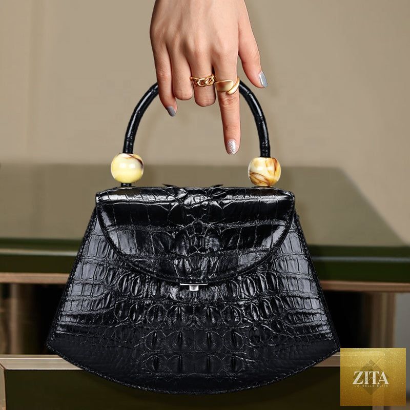 Luxury women's crocodile handbag by donjohnbyvictoriacharles, showcasing a textured crocodile leather exterior and elegant design.