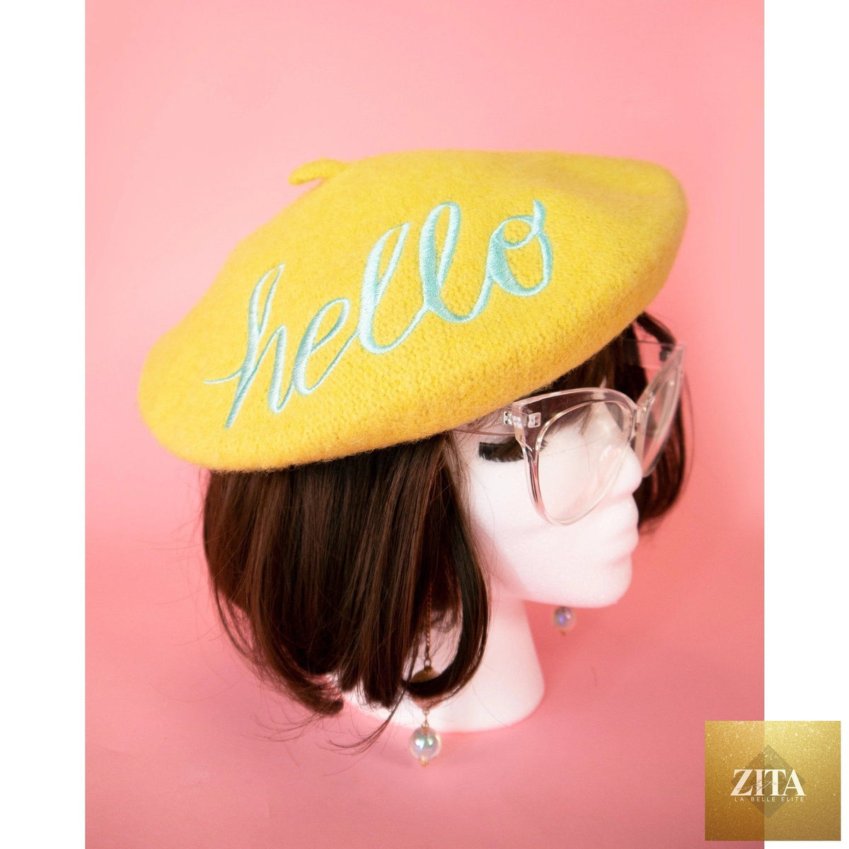 Yellow embroidered beret hat with "Hello" written in stylish embroidery, by The Bullish Store.
