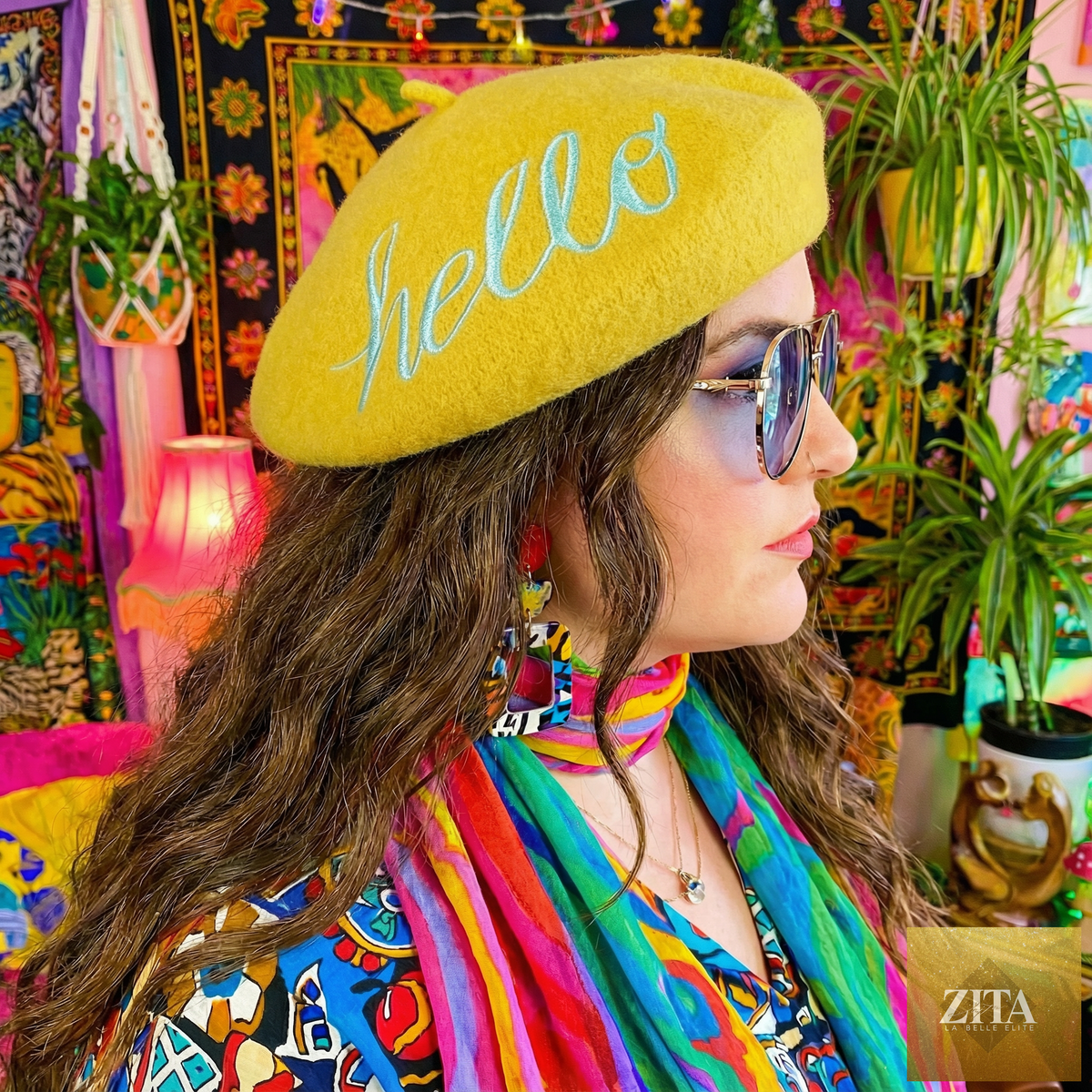Yellow embroidered beret hat with "Hello" message from The Bullish Store, stylish and cozy accessory for casual wear.