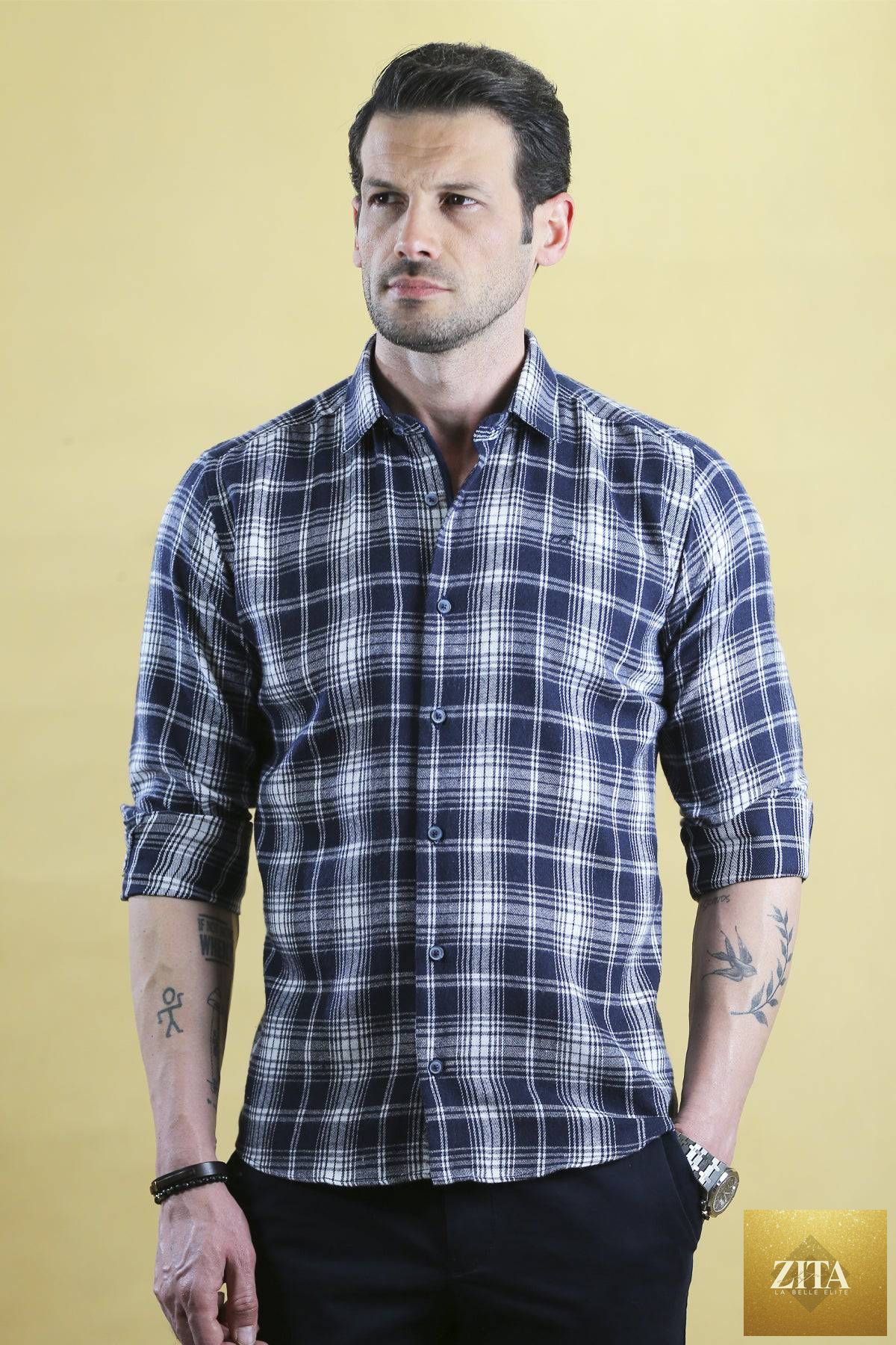 Navy plaid Woodsman Shirt by Bright Moons displayed on a hanger, showcasing its classic pattern and casual fit.