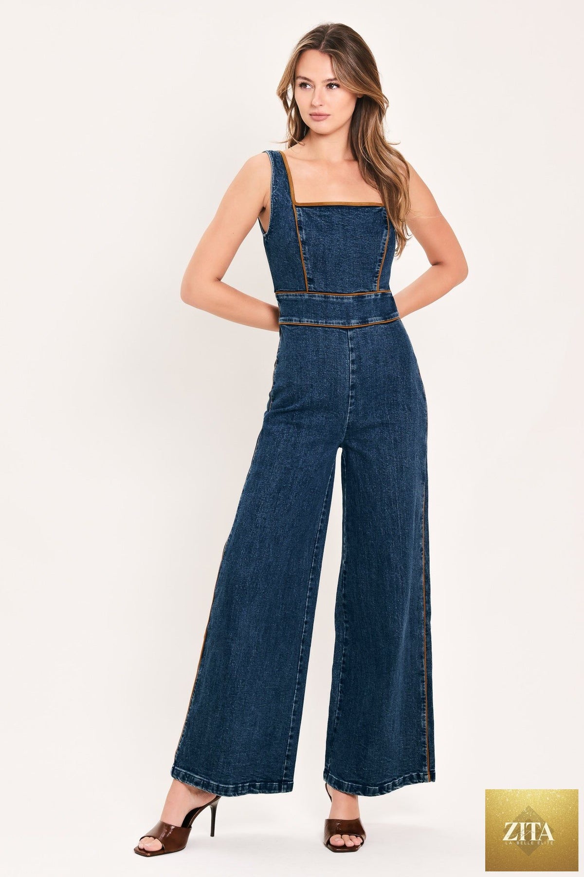 Flying Tomato Western Star Daydream denim jumpsuit in medium indigo with front pockets and adjustable straps.