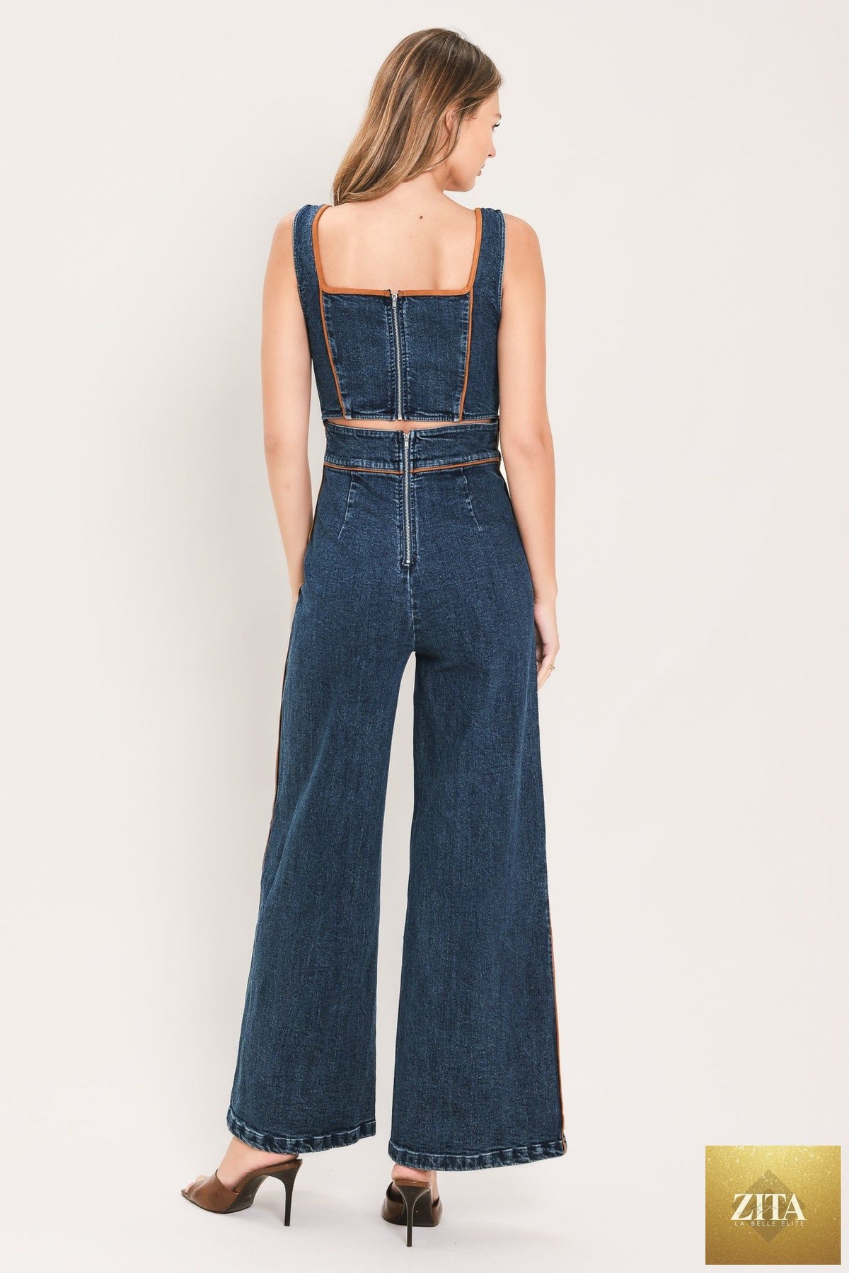 Flying Tomato Western Star Daydream denim jumpsuit in medium indigo, featuring a fitted style with button details and adjustable straps.