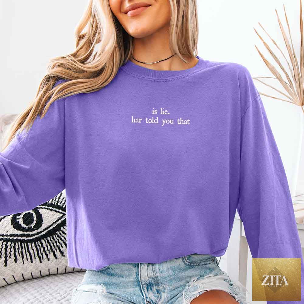 Comfort Colors long sleeve T-shirt featuring the "Is Lie, Liar Told You That" design in violet, from Adorb Custom Tees, ideal for book lovers.