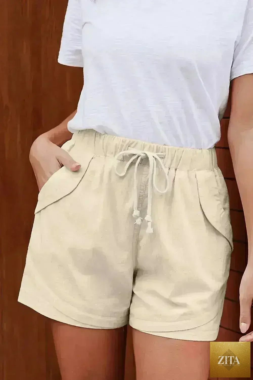 Casual beige Faylin women's shorts by Femstylo, featuring a relaxed fit and lightweight fabric, suitable for warm weather.