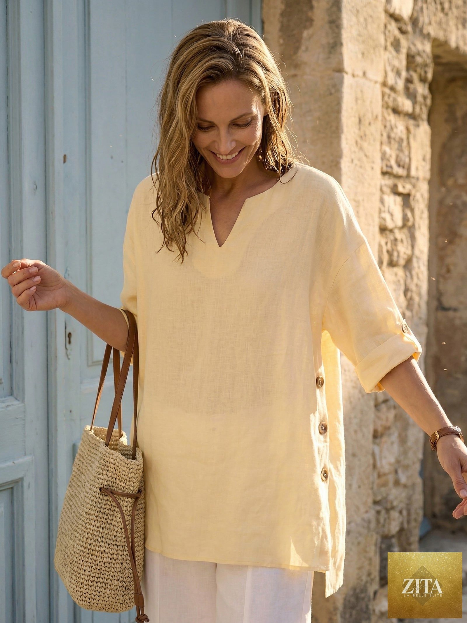LINTICO Daphnea oversized linen top with curved hem in soft butter color, relaxed fit and breathable fabric.