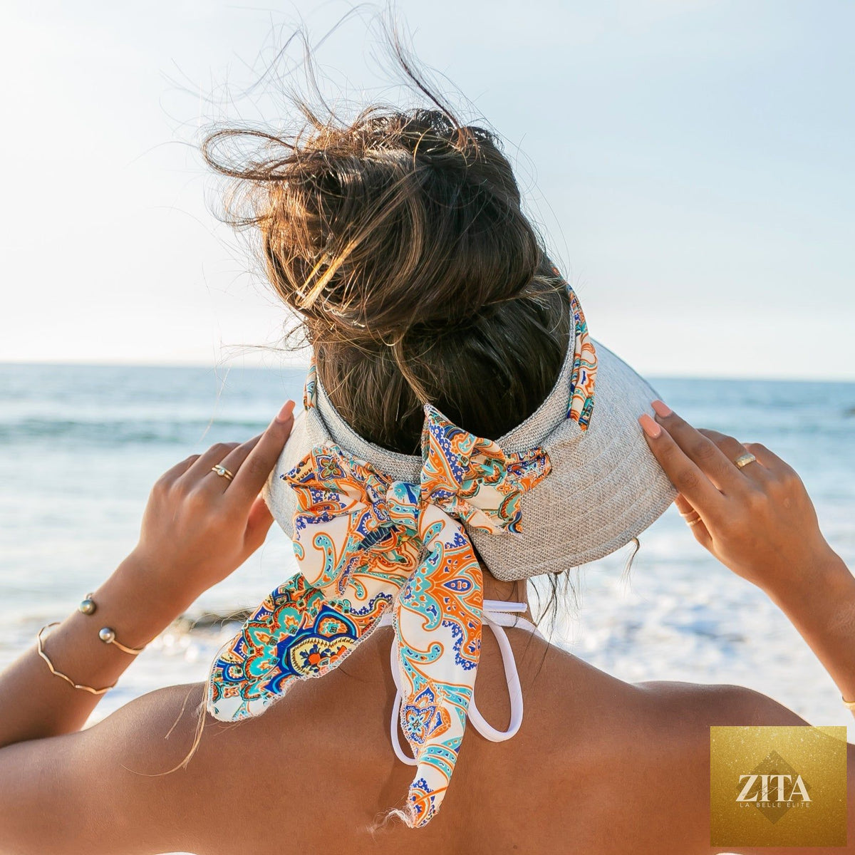 Aili's Corner sun visor with a stylish scarf accent, featuring a wide brim and lightweight design for sun protection.