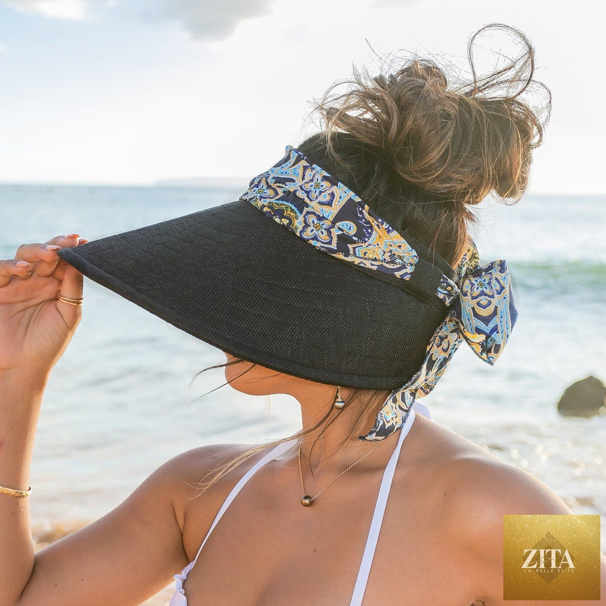 Aili's Corner sun visor with a stylish scarf accent, featuring a wide brim and lightweight fabric for sun protection and fashionable flair.