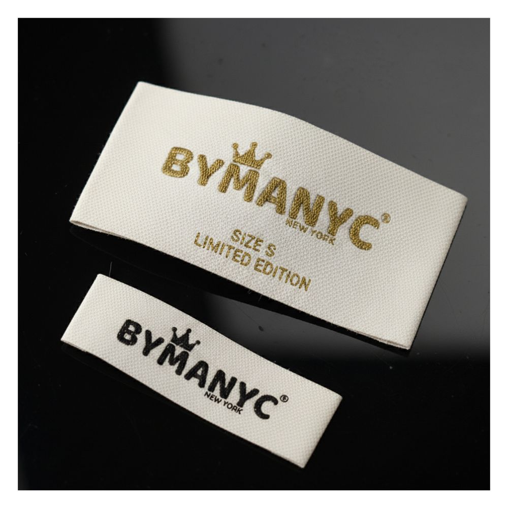 Black mini bodycon dress with button tassel for women, BYMANYC New York, featuring a sleek, fitted design perfect for evening wear.