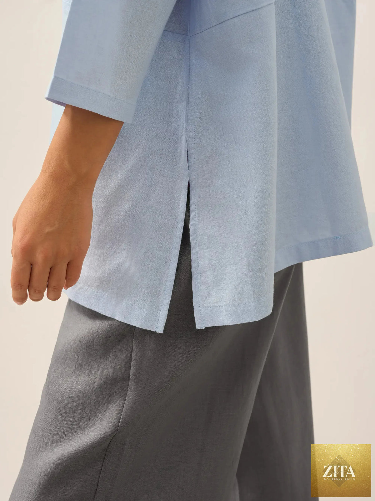 Linen white boat neck oversized top by LINTICO, made of linen blend, displayed on a hanger against a plain background.