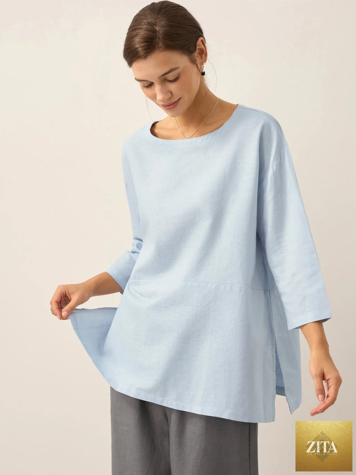LINTICO linen white boat neck oversized blouse, made from linen blend fabric, with a relaxed fit and sky blue accents.