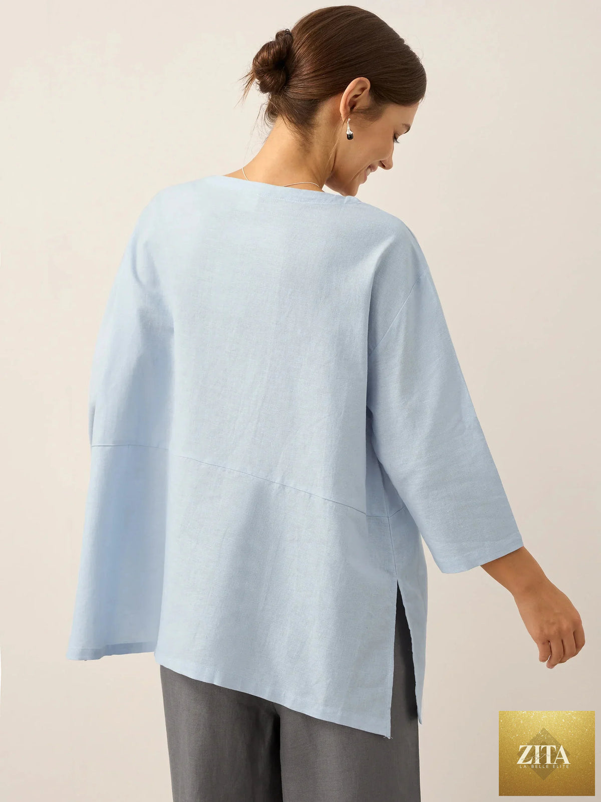LINTICO linen white boat neck oversized top with a relaxed fit, made from linen blend fabric, displayed against a plain background.