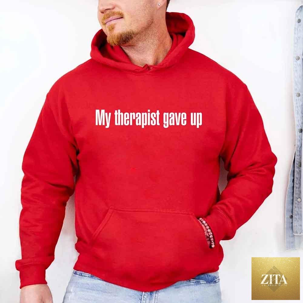 Gray hoodie with bold white text reading "My Therapist Gave Up," featuring humorous, sarcastic design by Adorb Custom Tees.