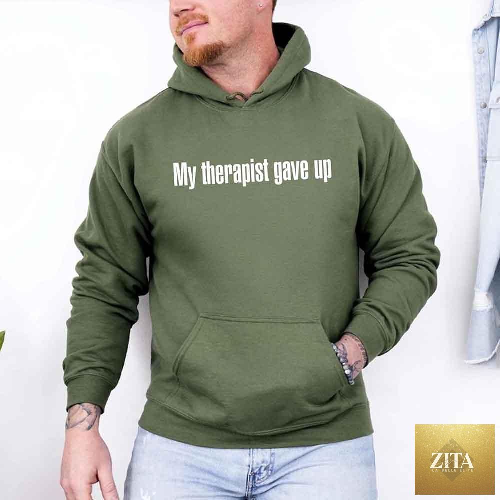 Black hoodie from Adorb Custom Tees featuring humorous "My Therapist Gave Up" sarcastic slogan, casual and comfortable fit.