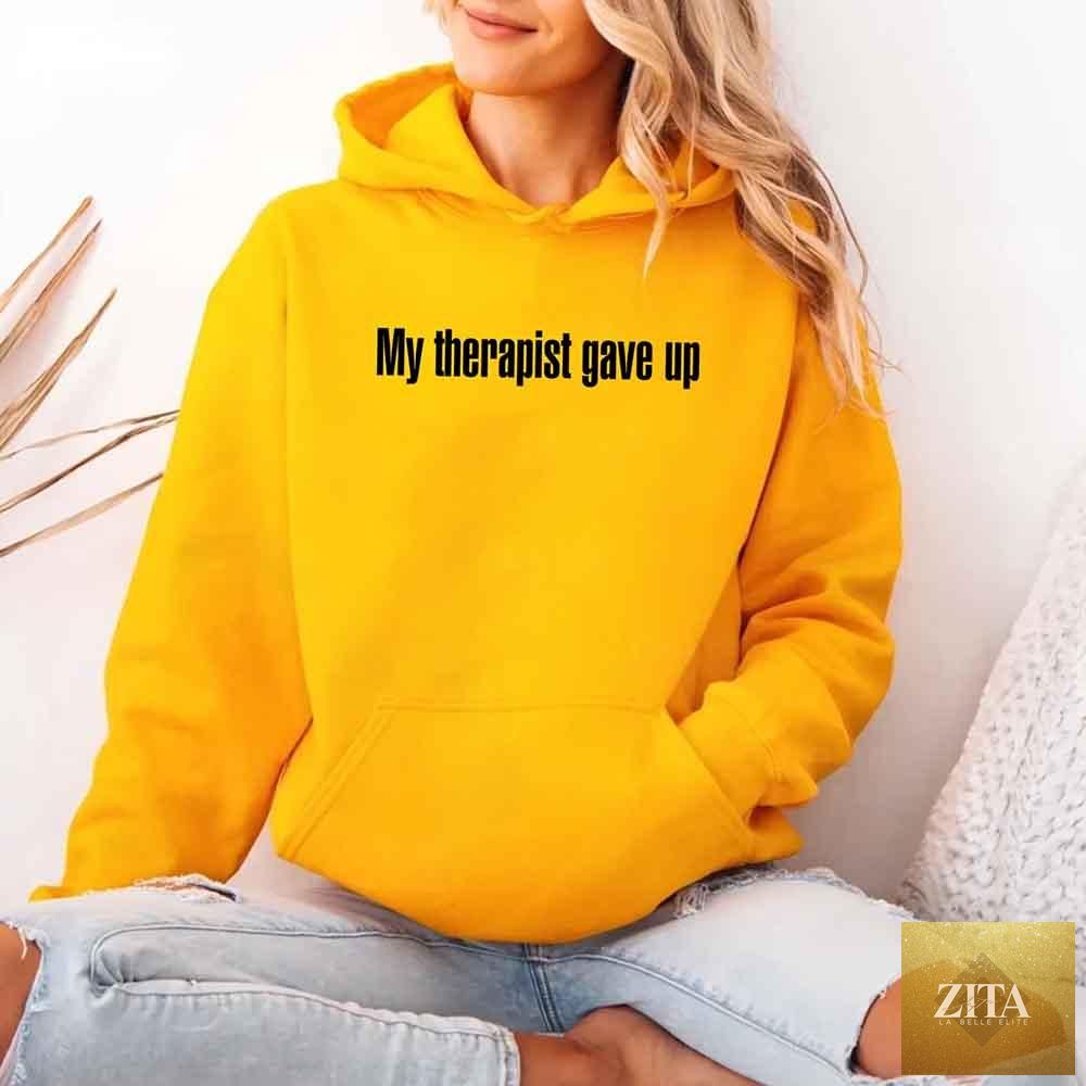 Black hoodie from Adorb Custom Tees with humorous "My Therapist Gave Up" slogan, featuring casual fit and comfortable fabric.