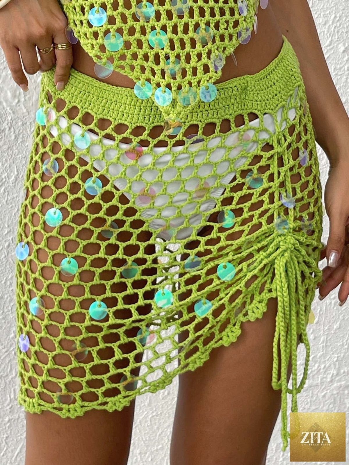 Women’s Bella Mia tight skirt with crochet stitching, asymmetric hem, drawstring strap, and hollow out cutout design for beach vacation style.