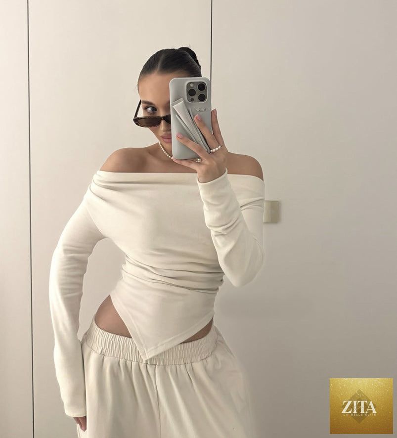 Asymmetric hem long T-shirt and straight-leg trousers in a casual two-piece set by Wanita Store, featuring fall-off neck design.