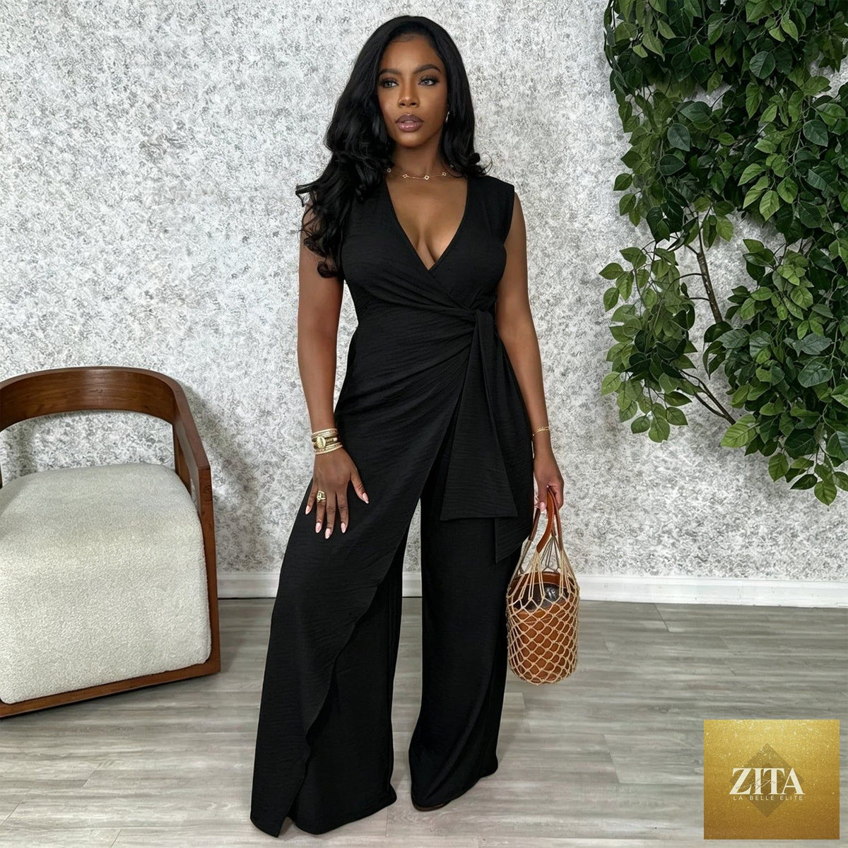 Women’s sleeveless V-neck cross straps wide-leg office jumpsuit by Bella Mia, showing the stylish split top and flowing pant legs.