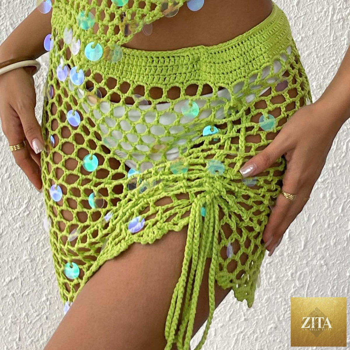 Bella Mia women's tight beach skirt with sequin stitching, crochet design, asymmetric cutouts, drawstring straps, and hollow out details.