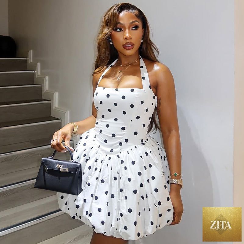 Black and white polka dot women’s sleeveless A-line dress with halter neckline, pleated design, by Ragazza.