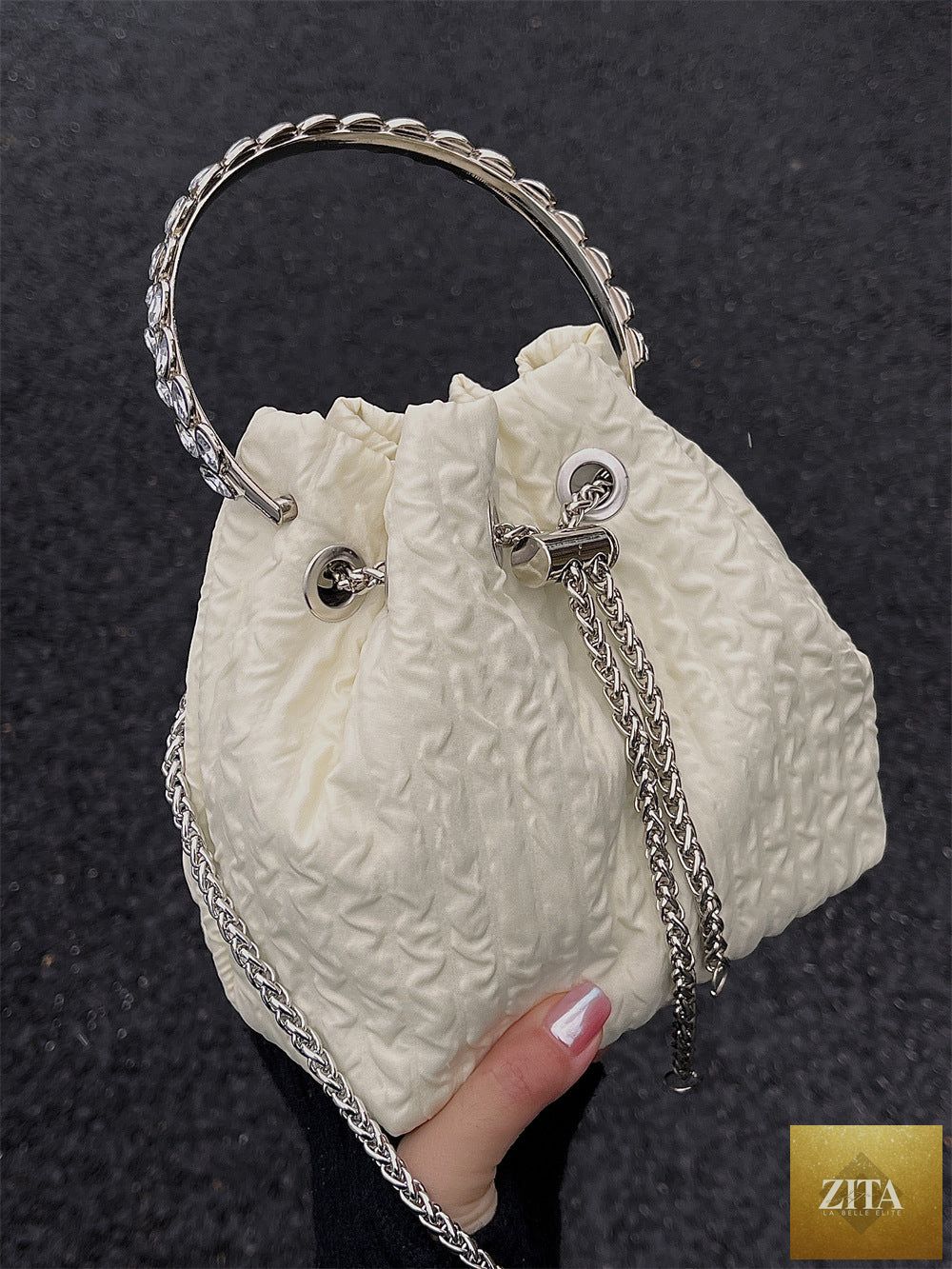 Luxury nude women's evening bag featuring rhinestone chain details, drawstring bucket style, perfect for parties and formal events.