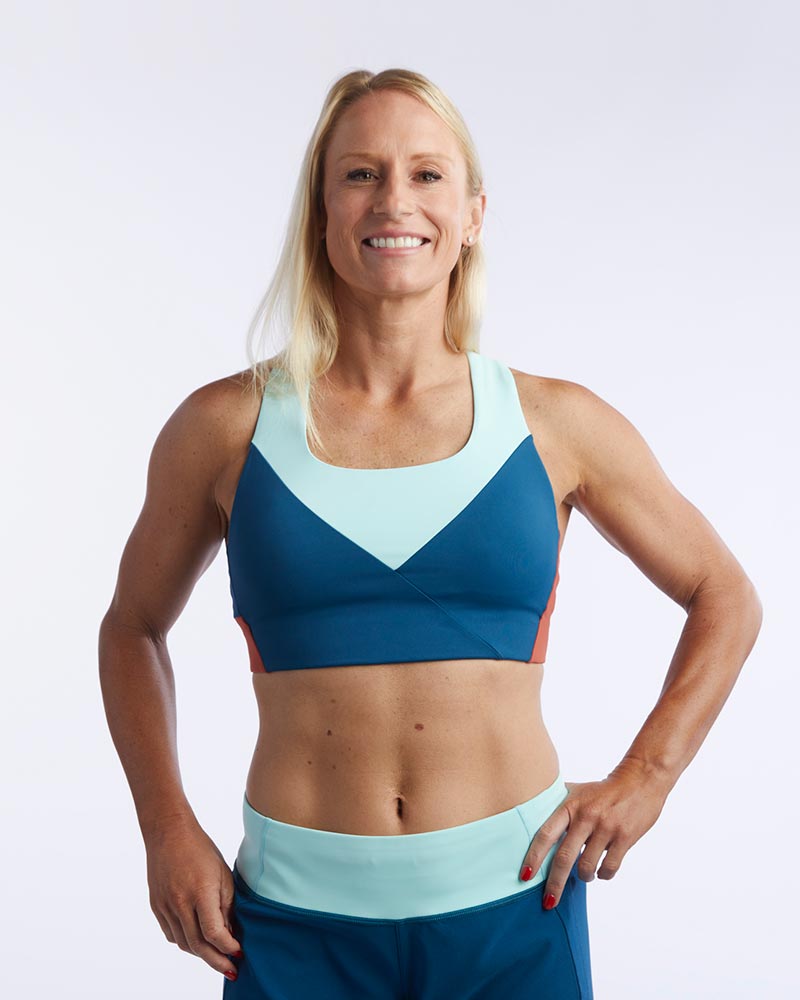 Dark teal and cinnabar Pionxr training bra top by Goal Five, shown from the front with supportive design and breathable fabric.