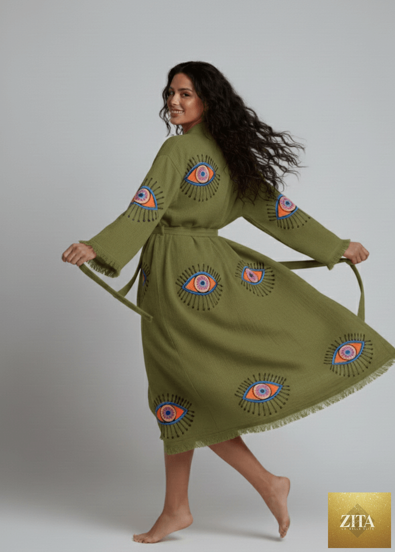 Green evil eye hand-printed kimono by Zita La Belle Elite, featuring natural fabric and intricate eye pattern design.