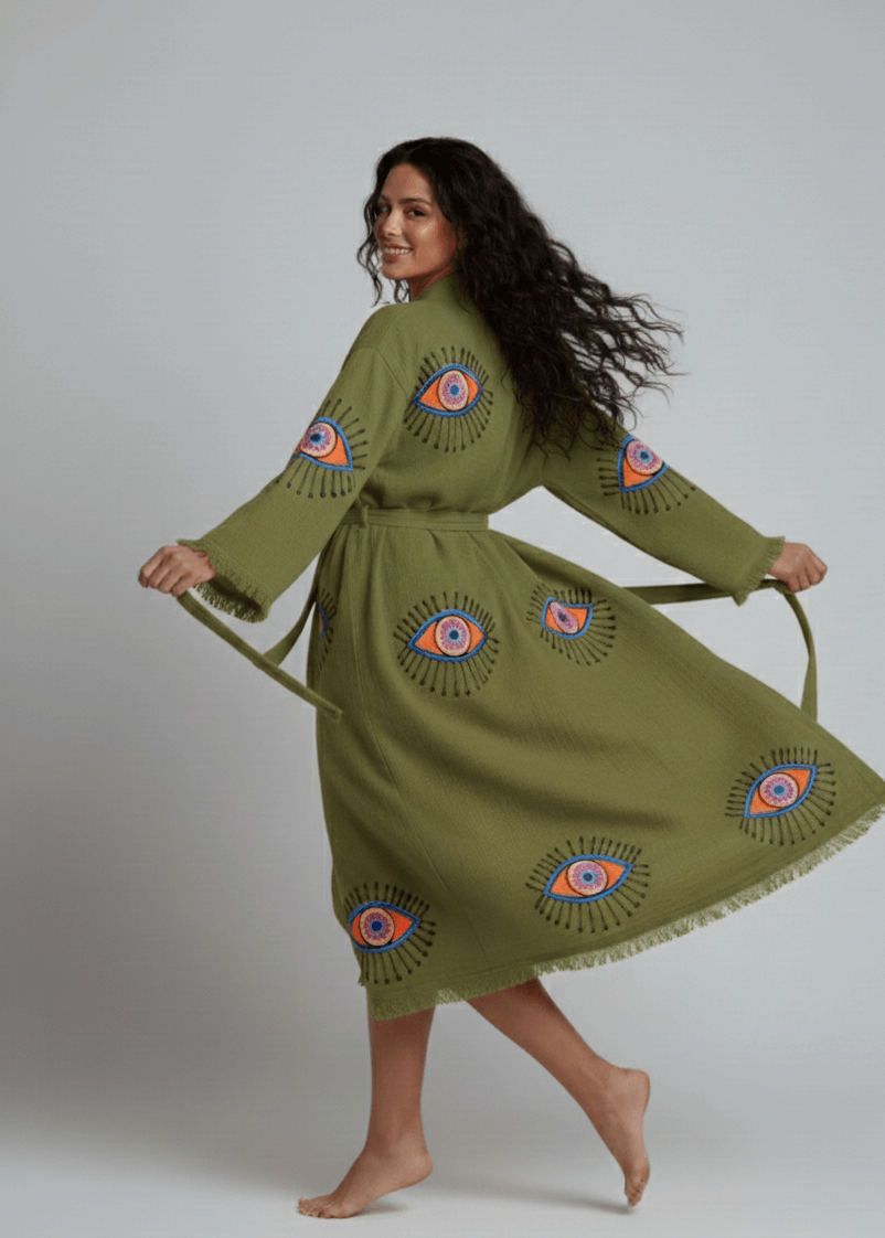 Green evil eye hand-printed kimono by Buldano featuring natural fabric and traditional design, displayed on a plain background.