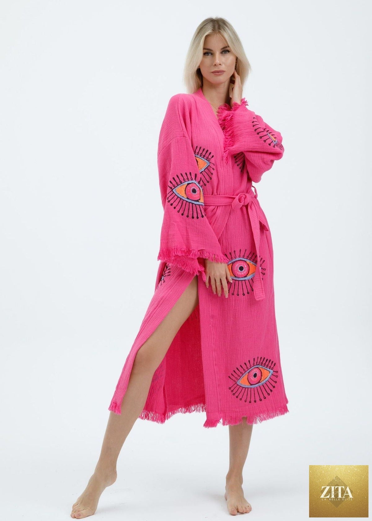 Hand-printed pink evil eye kimono by Zita La Belle Elite, featuring natural fabric and intricate eye pattern design.
