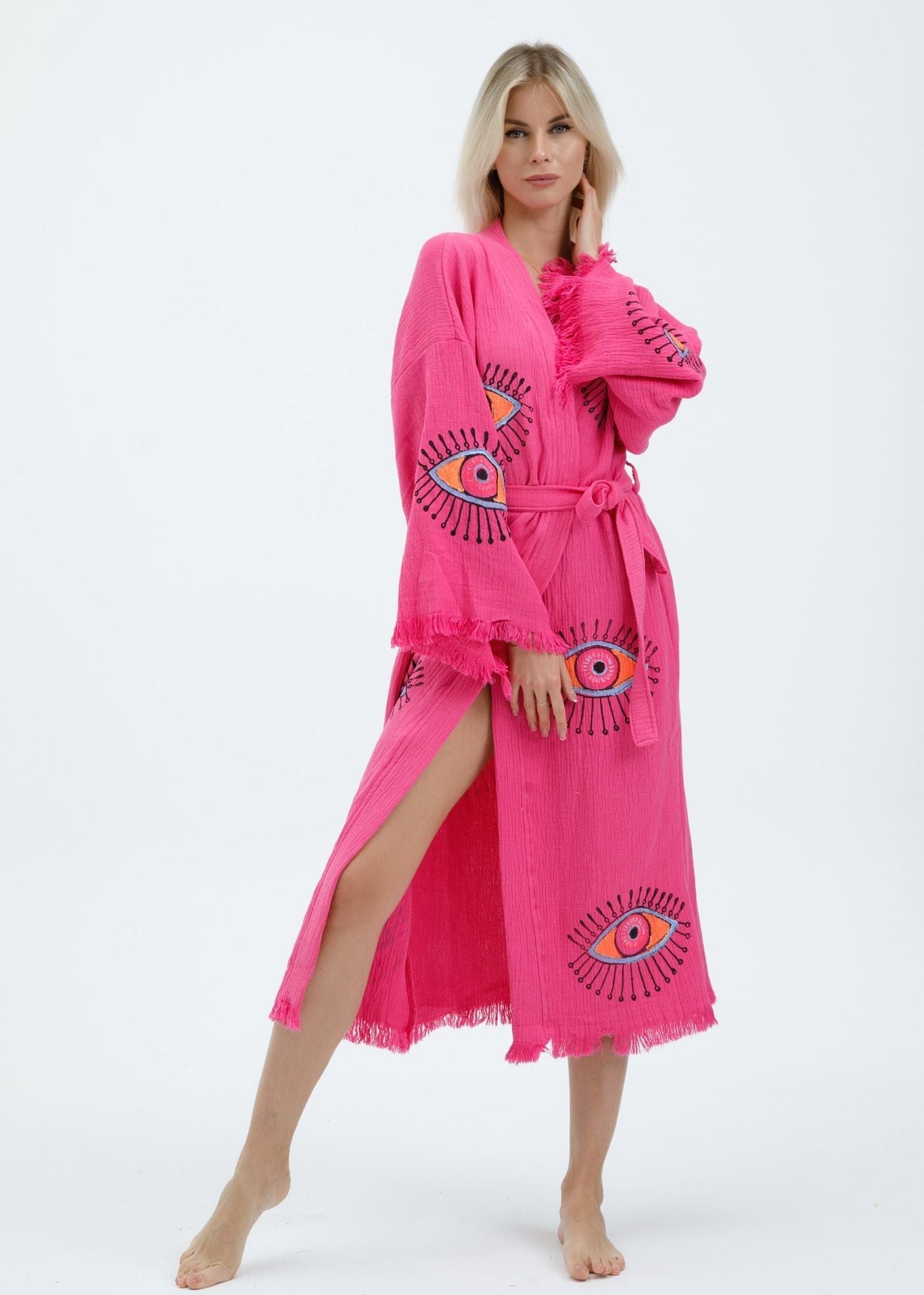 Hand-printed pink evil eye kimono by Buldano featuring natural fabric and intricate design, flowing open-front style.