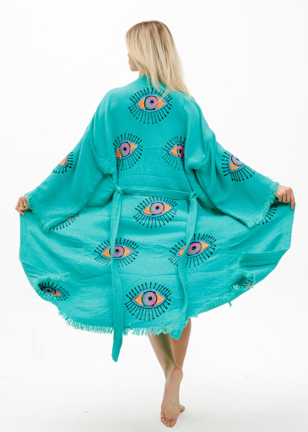 Hand-printed teal evil eye kimono by Buldano featuring natural fabric and intricate design, displayed on a neutral background.